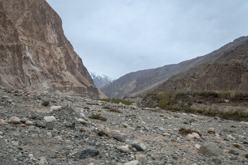 Scenic view of Himalayas and Ladakh ranges. Beautiful barren hills in Ladakh with dramatic clouds in the background.  View from the road from Nubra Valley to Turuk. 