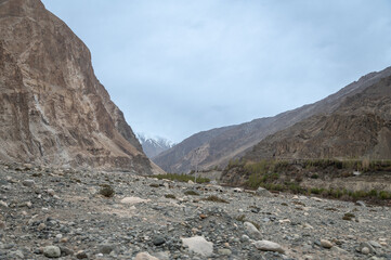 Scenic view of Himalayas and Ladakh ranges. Beautiful barren hills in Ladakh with dramatic clouds in the background.  View from the road from Nubra Valley to Turuk. 