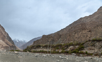 Scenic view of Himalayas and Ladakh ranges. Beautiful barren hills in Ladakh with dramatic clouds in the background.  View from the road from Nubra Valley to Turuk. 