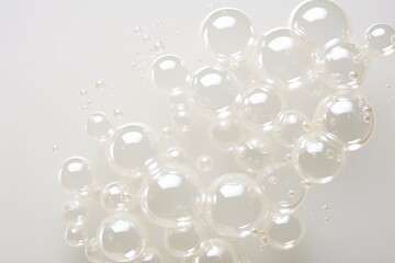  a bunch of bubbles sitting on top of a white table next to a bottle of water and a cell phone.