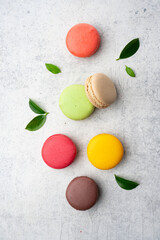 Sweet and colored macaroons on vintage background