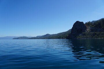 View of Cave Rock on the East Shore of Lake Tahoe from the water, on a summer day with clear blue skies