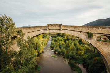 Naklejka premium Vieux pont en pierre dans le sud de la France. Pont du diable à Céret. Pont en arche. Pont élevé contre les crues. Pont dans les Pyrénées orientales. Rivière sous un pont haut.