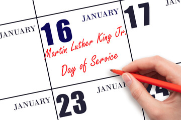 January 16. Hand writing text Martin Luther King Jr. Day of Service on calendar date. Save the date.