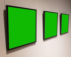 Paintings on the wall with a green background
