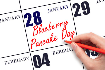 January 28. Hand writing text Blueberry Pancake Day on calendar date. Save the date.