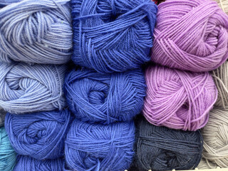 Multicolored skeins of yarn for knitting as a background.
