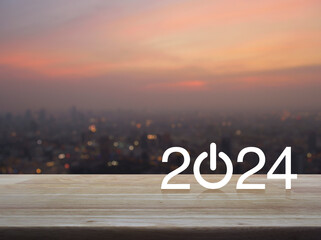 2024 start up business flat icon on wooden table over blur of cityscape on warm light sundown,...