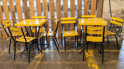 vintage empty coffee shop with trendy 70s interior design tables and yellow chairs