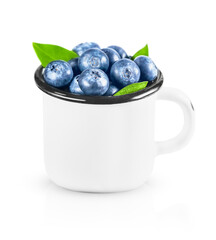 white metal mug filled with ripe blueberries. isolated on a white background