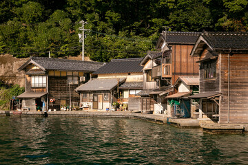 Fototapeta na wymiar Beautiful fishing village of Ine in the north of Kyoto. Funaya or boat houses are traditional wooden houses built on the seashore.
