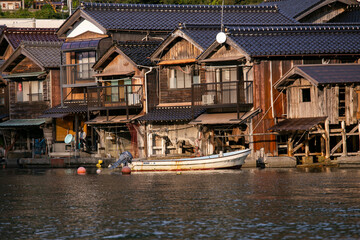 Fototapeta na wymiar Beautiful fishing village of Ine in the north of Kyoto. Funaya or boat houses are traditional wooden houses built on the seashore.