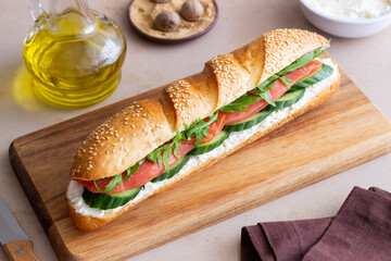 Sandwich with salmon, white cheese, cucumber and arugula. Breakfast. Fast food.