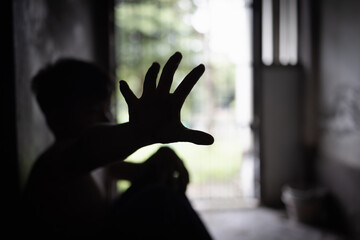 Child abuse concept, silhouette of  child confined in a dark room, prisoner or child abduction,...