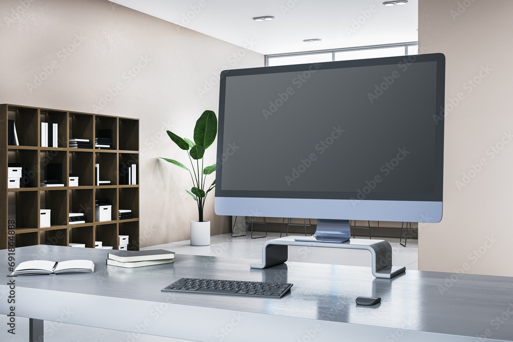 Poster Close up of gray desk with blank computer monitor, daylight and bookshelf in the background. Mock up, 3D Rendering.