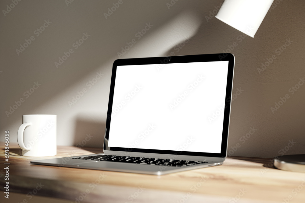 Poster modern blurry daytime desktop with blank white laptop screen, lamp and coffee cup. designer workspac