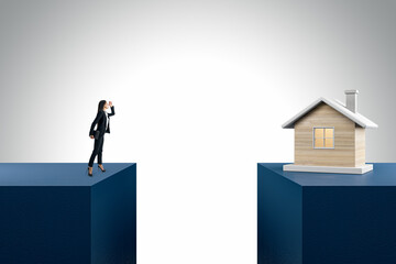 Businesswoman and wooden house divided by gap on light background. Mortgage and loan concept.