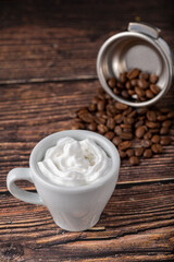 Obraz na płótnie Canvas Espresso con panna in white porcelain cup on wooden table