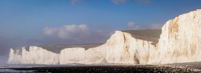 Panoramic view of the chalk cliffs of the seven sisters on the south downs from Birling Gap beach...