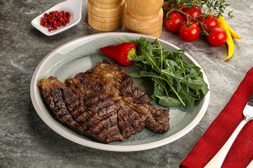 Grilled chuck roll steak with arugula