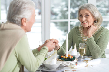 Elderly couple at the dinner table with champagne.