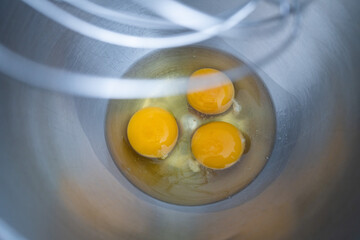 Three eggs in a bowl ready to be blended.