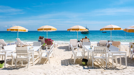 beach chairs sunbed with umbrellas at the white tropical beach of Samed Island with a turqouse...