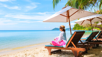 Asian Thai woman on a beach chair on the beach of Koh Samet Island Rayong Thailand, the white...