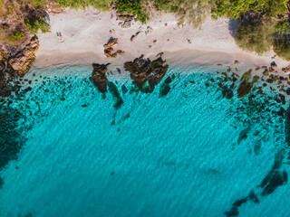 Koh Samet Island Thailand, aerial drone view from above at the Samed Island in Thailand with a turqouse colored ocean and a white tropical beach at a lonely bay lagoon