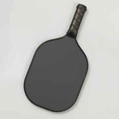 Top view of a black blank pickleball paddle on light gray background with copy space. Square composition