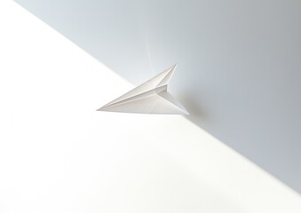 Fototapeta na wymiar A minimalist composition featuring a white paper airplane soaring through the air against a white