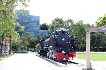 Old head of steam locomotive renovate and present on railroad in public park, Thailand.