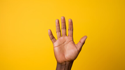 Naklejka premium Giving high five hand on yellow background