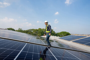 Engineer service check installation solar cell on the roof of factory. Silhouette technician...