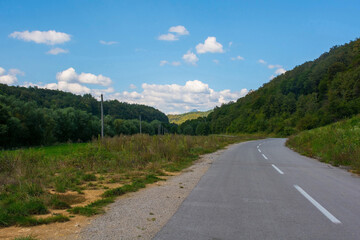 Fototapeta na wymiar A country road just north of Martin Brod, Bihac, in the Una National Park. Una-Sana Canton, Federation of Bosnia and Herzegovina. Early September