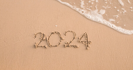 2024 year written on the beach in the sunset time. New Year 2024 concept