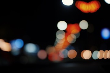 Colorful defocused bokeh abstract background created by city night lights. Blurred defocused colorful lights of traffic in the city. selective focus.