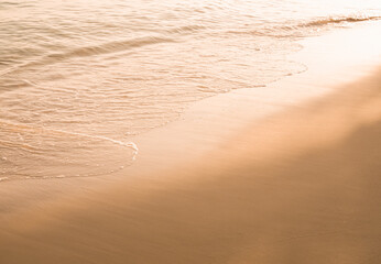 Water and sand at the beach in sunset time