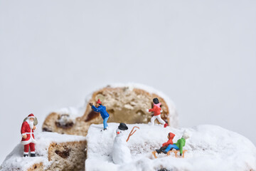 Santa Claus and children on a Christmas cake, miniature figures scene Christmas theme