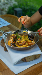 women eating seafood pasta. 