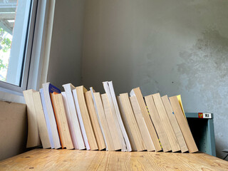 Old Books Stacked on wooden table in Natural Light
