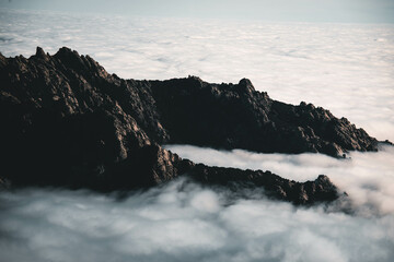 Beautiful mountains under a sea of ​​clouds during a cloudy day