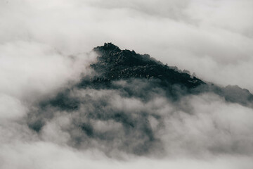 Beautiful mountains under a sea of ​​clouds during a cloudy day