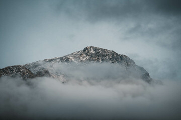 Beautiful mountains under a sea of ​​clouds during a cloudy day