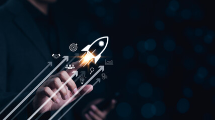 Businessman touching rocket with up arrow and business investment icon. Rocket soars with speed to...