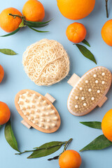 Brushes for dry massage with tangerines. Eco cosmetics, home body care, vitamin C for the winter. Natural cosmetics product background.  Zero emission, square crop