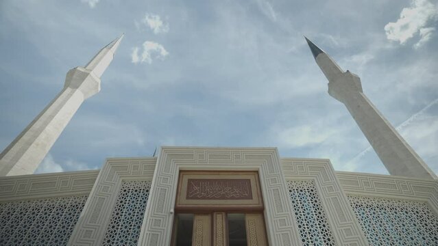 The door entrance and minarets of Ahmet Hamdi Akseki Mosque can be seen. Translation: ''Now you remember me and I will remember you. Be grateful to me, do not be ungrateful to me!''