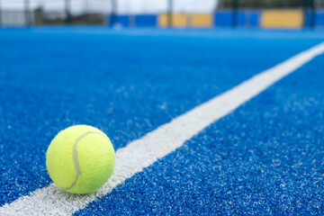 ball on a paddle tennis court line