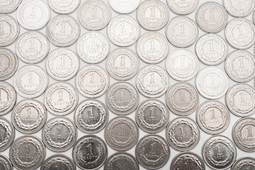 Polish Zloty coins. 1 PLN coin background on the white table. - obrazy, fototapety, plakaty