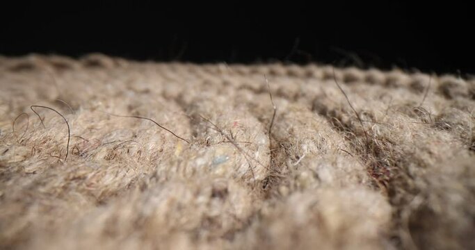 Closeup of nautical braided rope on black background. Polyamide braided rope